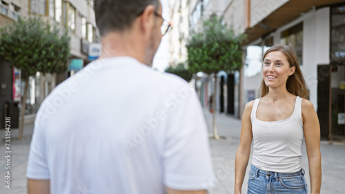 Father and daughter, standing together on a sunny city street, looking into each other's eyes, smiling with confidence, and radiating joy and love