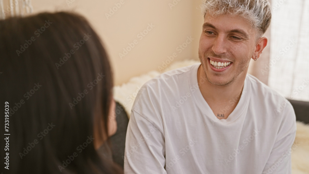 A smiling man and woman in a candid moment of joy inside a cozy room, depicting a loving couple's relationship. A smiling man and woman in a candid moment of joy inside a cozy room, depicting a loving couple's relationship.