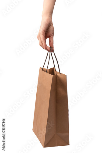 Paper bag in woman hand isolated on a white background.