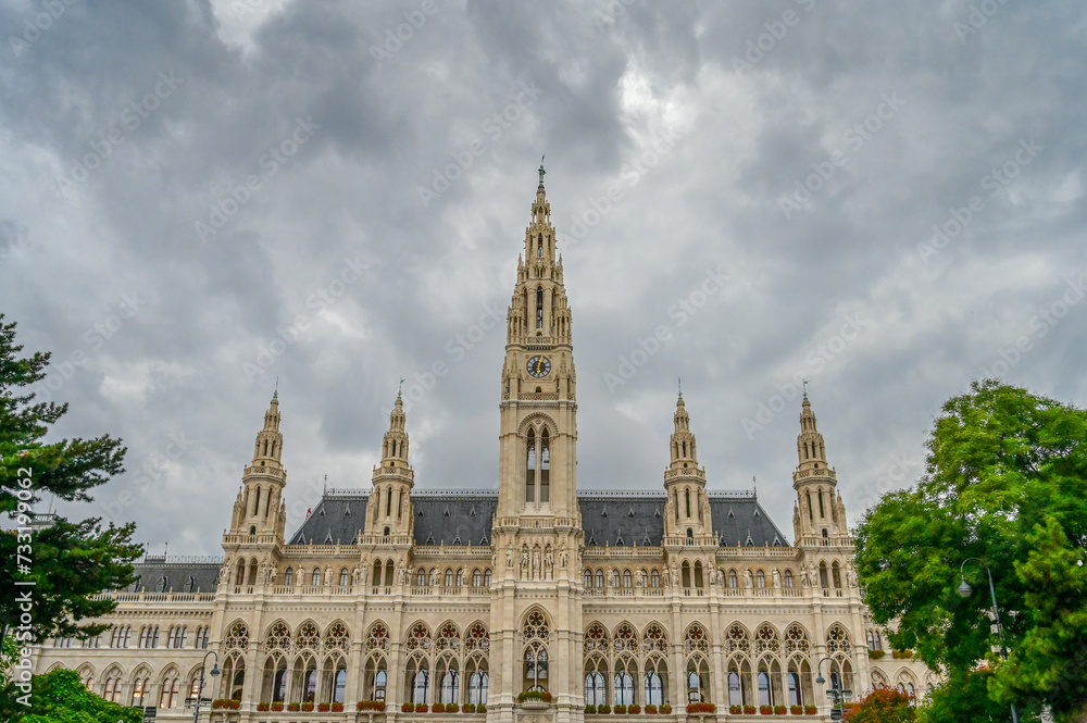 Vienna, Austria: The Vienna City Hall building on Rathausplatz with dramatic dark clouds in background. Office of the Mayor of Wien, seat of city council and local government.