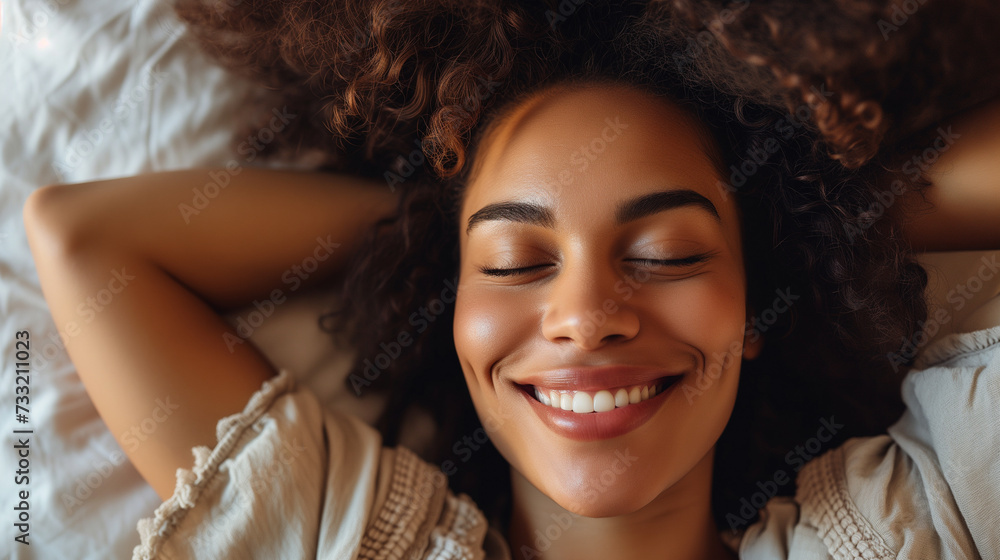 young african american woman relaxing with eyes closed at home, she is smiling