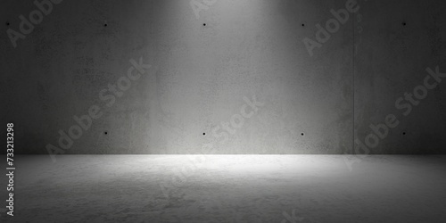 Abstract empty, modern concrete room with spot light shining down on the back wall and rough floor - industrial interior background template