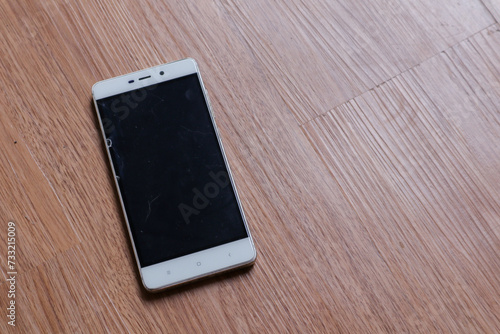 a smartphone over a wooden background