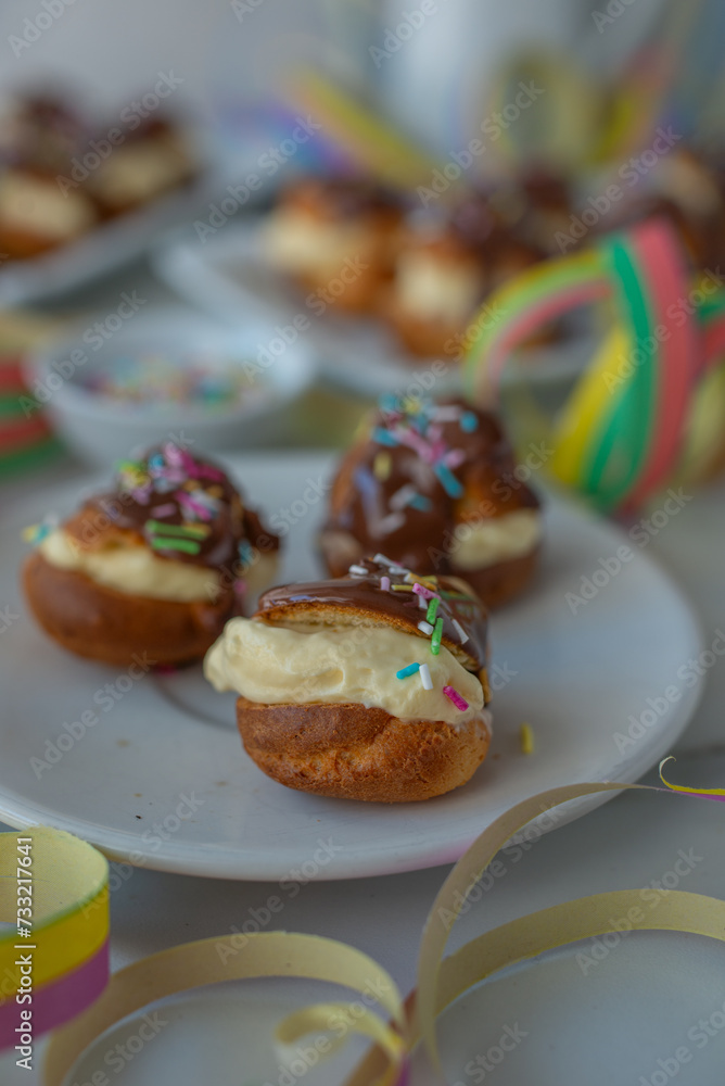 Delicious profiteroles with cream and chocolate glaze Delicious profiteroles with cream and chocolate glaze