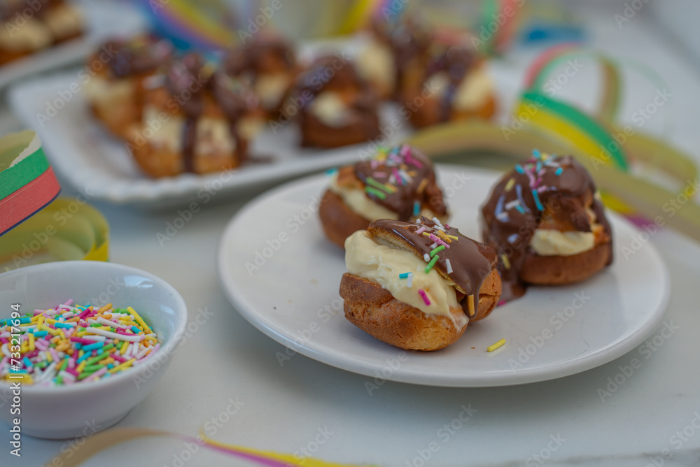Delicious profiteroles with cream and chocolate glaze Delicious profiteroles with cream and chocolate glaze