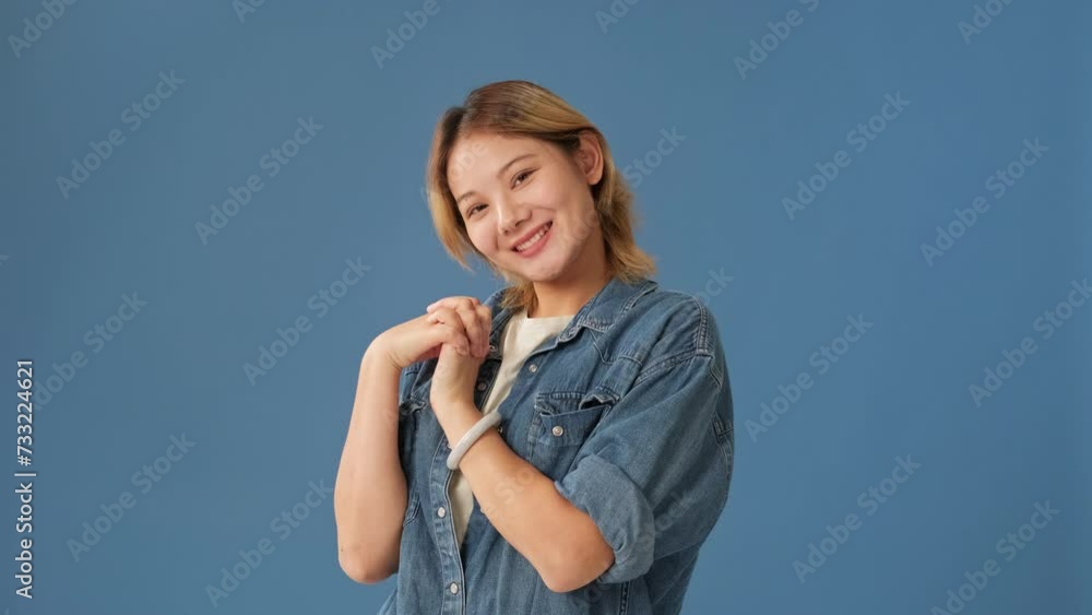 Smiling young woman it so sweet put hands on chest looking at camera isolated on blue background Smiling young woman it so sweet put hands on chest looking at camera isolated on blue background