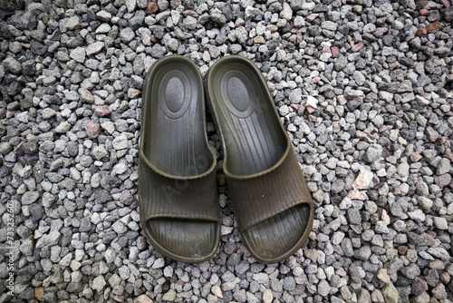 sandals with a background of small rocks or pebbles