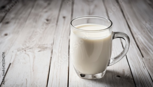 A glass of milk on a wooden table