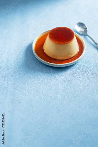 homemade Japanese caramel custard pudding on white  ceramic plate.