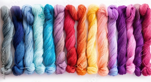 A vibrant display of diverse skeins of yarn lined up in a neat row, showcasing a variety of colors.