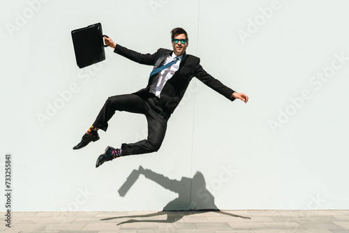 Flexible and cool businessman doing acrobatic trick