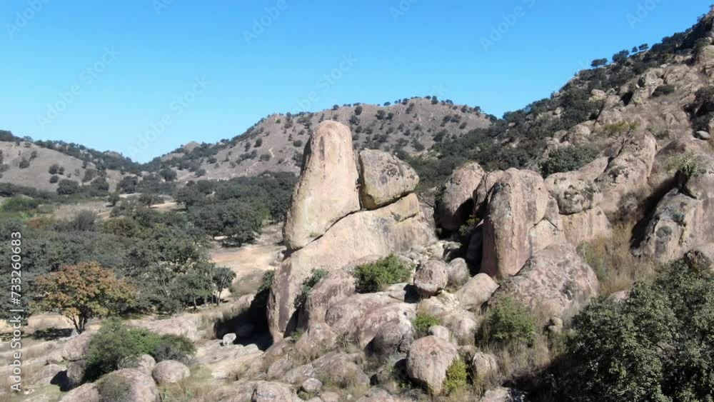 The drone flying around the rock and one person is climbing showing us the landscape in the mountains The drone flying around the rock and one person is climbing showing us the landscape in the mountains