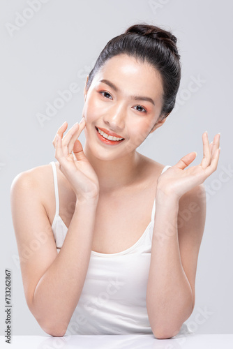 Beautiful Asian woman looking at camera smile with clean and fresh skin Happiness and cheerful with positive emotional,isolated on white background. Beauty and Cosmetics Concept. Proud her self.