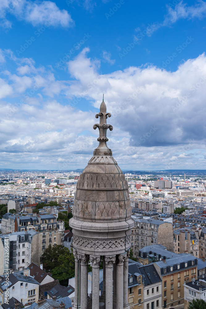 overlooking paris and cupola atop dome of sacre coeur reaching above horizon
