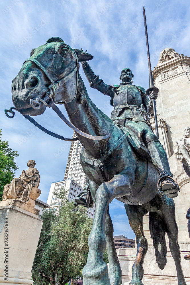 Fototapeta premium Don Quijote de la Mancha, with his horse Rocinante, the famous statue at Plaza de Espana of Madrid, Spain. It is the literary personage created by author Miguel de Cervantes and a symbol of Madrid. 