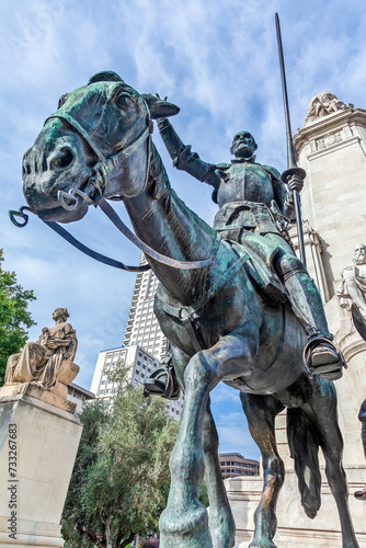 Don Quijote de la Mancha, with his horse Rocinante, the famous statue at Plaza de Espana of Madrid, Spain. It is the literary personage created by author Miguel de Cervantes and a symbol of Madrid.  photo