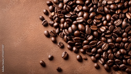 A pile of coffee beans on a brown surface
