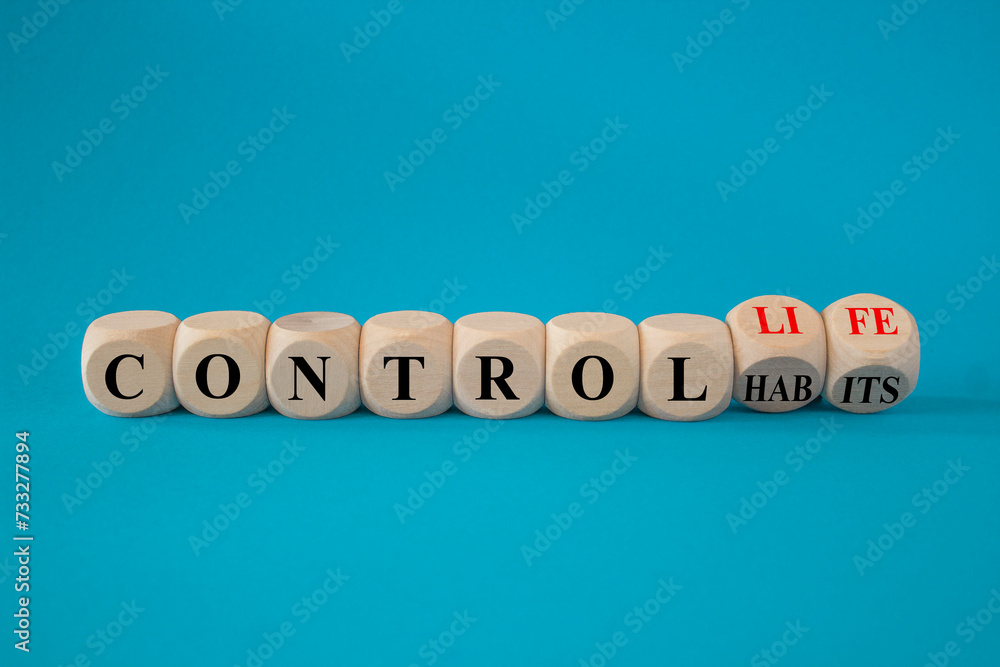 Concept red words Control habits to Control life on beautiful wooden cubes. Beautiful blue background, copy space. Business control habits and life concept.