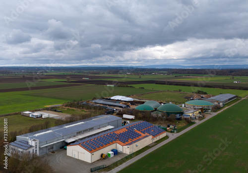 Biogas plant with solar cells in Hesse with Taunus in the background
