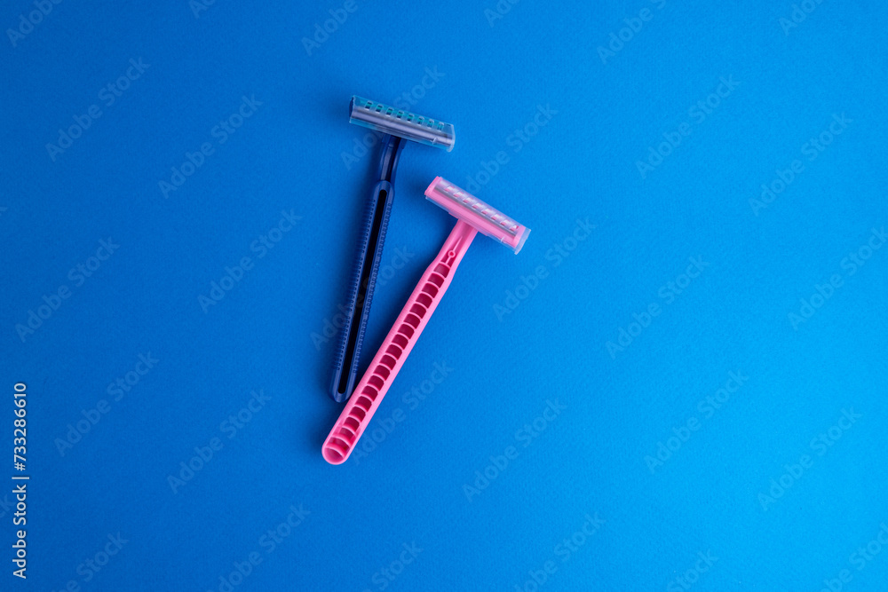 Disposable plastic razor with steel blade, men's and women's razors. Skin and body care concept. Depilation. Place for text Disposable plastic razor with steel blade, men's and women's razors. Skin and body care concept. Depilation. Place for text