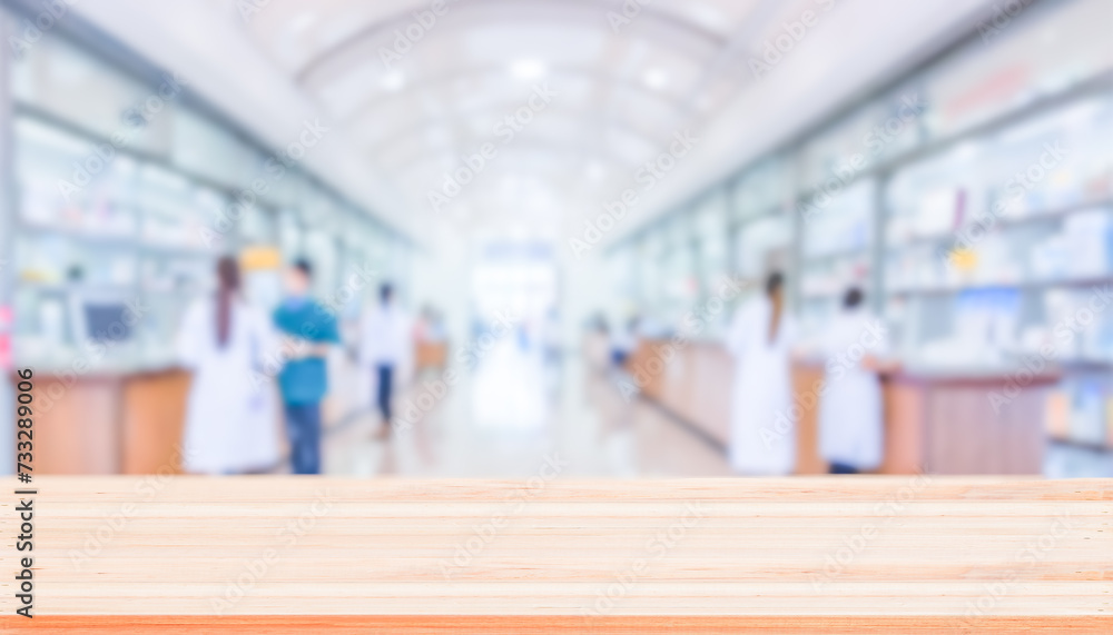 Fototapeta premium Empty natural wood counter top with blur pharmacy background