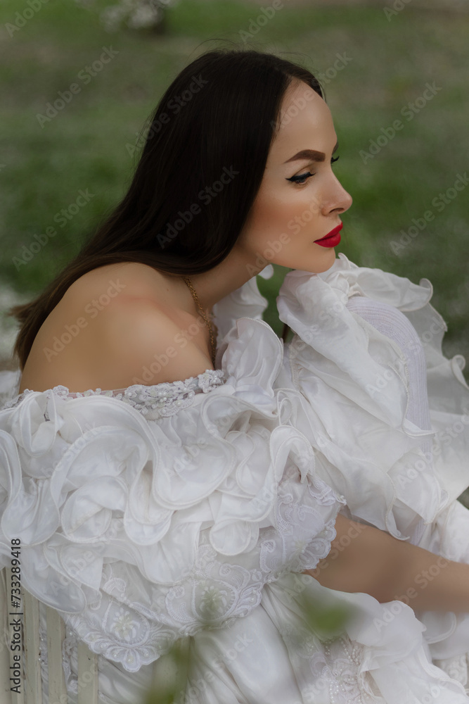 Spring sexy fantasy woman sits on branch of green tree blooming sakura flowers garden. Medieval girl vintage lady. pink silk fly in wind dress. fairy tale image art photo. Brunette long hair cute face Spring sexy fantasy woman sits on branch of green tree blooming sakura flowers garden. Medieval girl vintage lady. pink silk fly in wind dress. fairy tale image art photo. Brunette long hair cute face