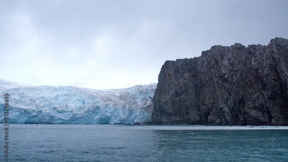 Glacier meeting the sea along a rugged cloastline on Elephant Island, Antarctica