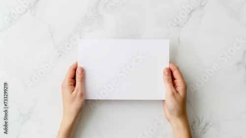 A top-down perspective of a school workspace with hands holdin a blank white paper, mental health and wellness, promoting focus and positivity in education, Workspace setup for learning and creativity