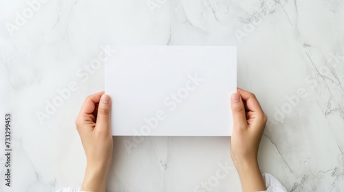 A top-down perspective of a school workspace with hands holdin a blank white paper, mental health and wellness, promoting focus and positivity in education, Workspace setup for learning and creativity