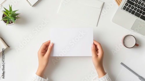 A top-down perspective of a school workspace with hands holdin a blank white paper, mental health and wellness, promoting focus and positivity in education, Workspace setup for learning and creativity
