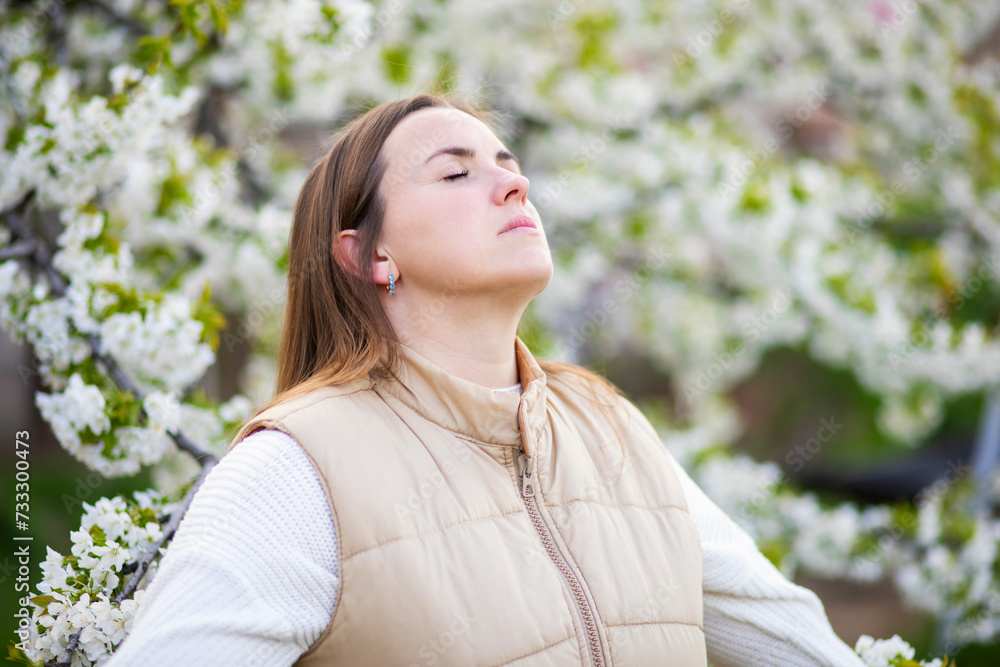 Woman Enjoying Serenity in Spring Blossoms Woman Enjoying Serenity in Spring Blossoms