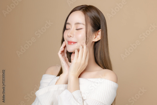 Young Asian beauty woman long hair with korean makeup style on face and perfect clean skin on isolated beige background. Female model, Facial treatment, Cosmetology, plastic surgery.