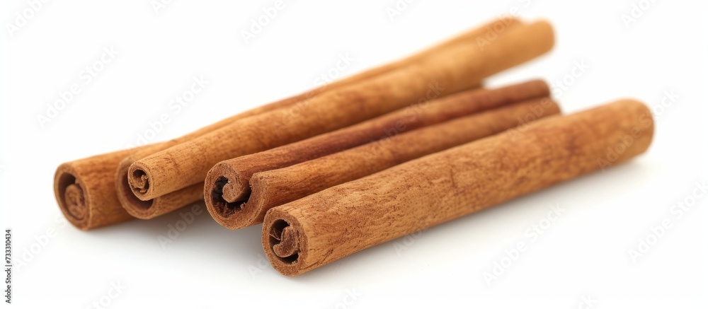 Three Isolated Cinnamon Sticks on a White Background