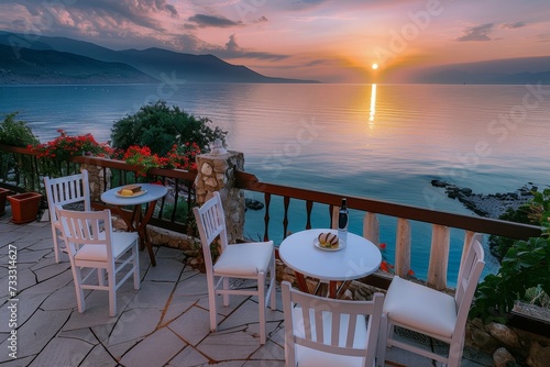 As the sun rises over the tranquil lake  a cozy patio set invites you to sit and take in the breathtaking landscape of the mountains in the distance  with the soft ocean breeze and the vibrant colors