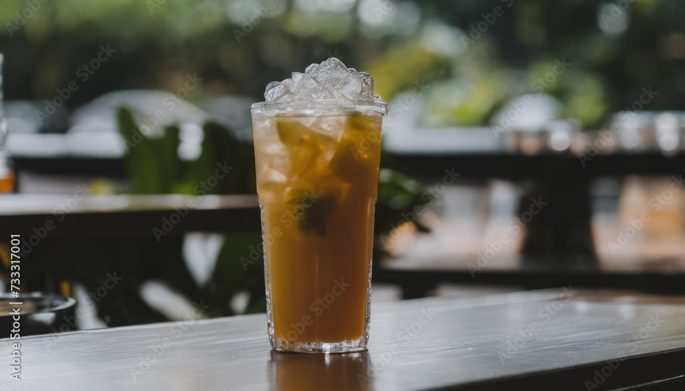 A glass of iced tea with a lemon wedge on top A glass of iced tea with a lemon wedge on top