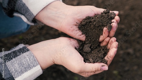 woman farmer pours environmentally friendly soil hands, touching soil field with fingers, farmer organic gardening engineer, growing seeds, growing vegetables field farm, business, hands soil close-up