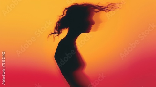 Female blurred silhouette on a orange background. Elegant outline of a woman in motion out of focus
