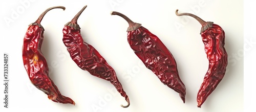 Vibrant Dried Red Peppers in Isolated White Background - A Scorching Trio of Dried, Red Peppers Set Against a Clean, White Canvas photo