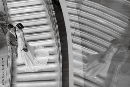 meeting of the bride and groom on the hotel stairs photo