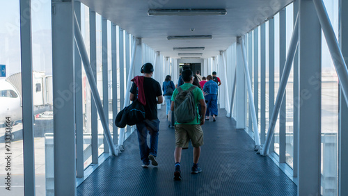 people walking towards the plane