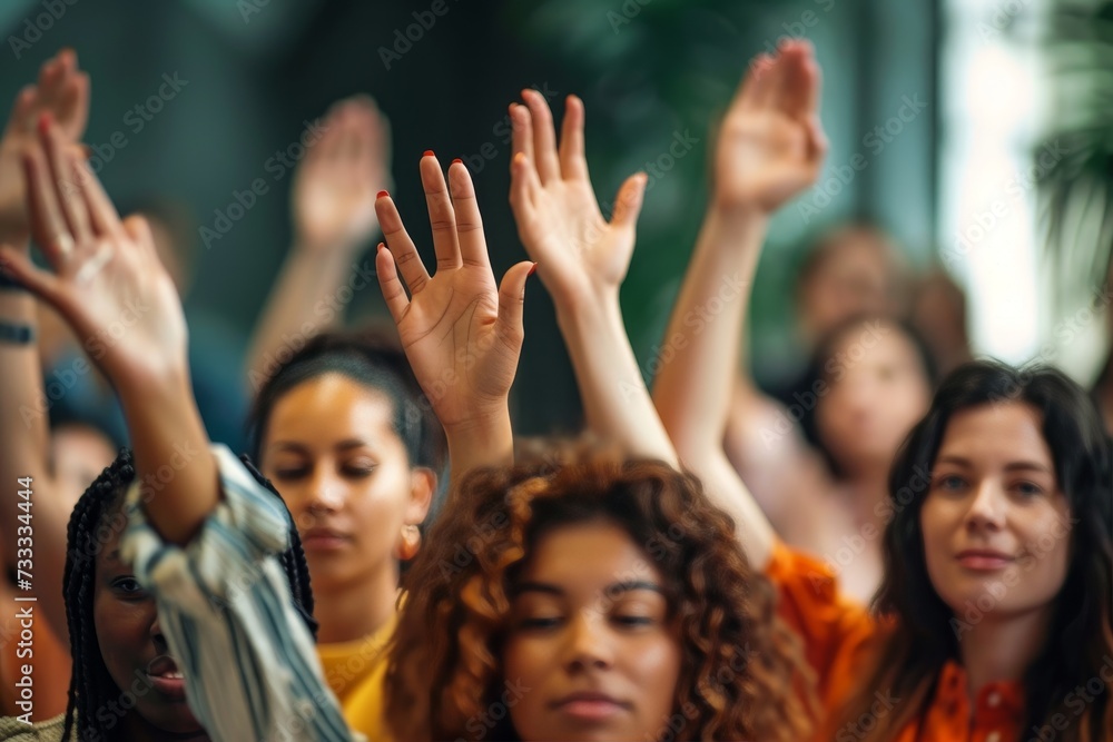 A joyful crowd of women proudly show off their unique styles and personalities as they raise their hands together in solidarity and celebration