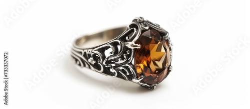 Antique silver ring featuring a sizable brown gem  separated on a white background.