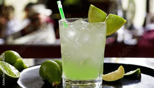 A green lime drink with a green straw