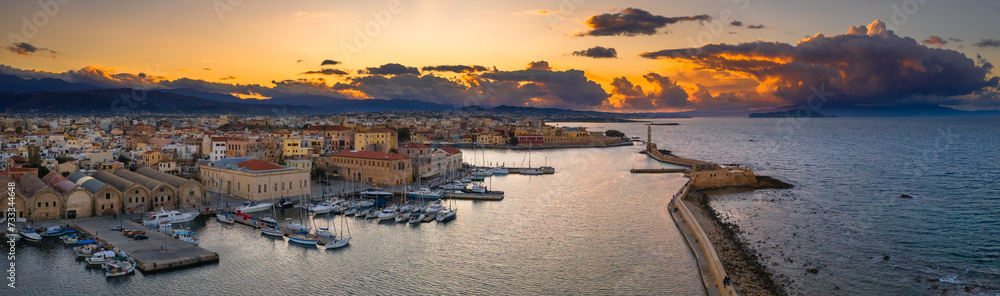 Chania with the amazing lighthouse, mosque, venetian shipyards, at sunset, Crete, Greece.