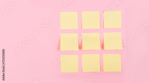 Banner with a clean yellow stickers on a pink background with place for text. Business concept. Tear-off paper for notes, reminders or quick temporary messages, organazer of thoughts and ideas