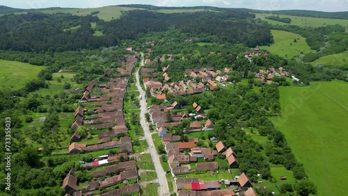 Aerial view of famous and traditional Village Viscri. Situated in Romania, Brasov this village become a famous travel destination after King Charles the III bought a vacation home here. Drone backward