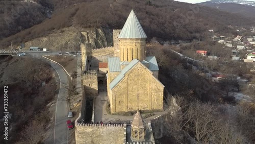 Aerial view of Ananuri Fortress Complex in Georgia. Ananuri fortress at the Zhinvali reservoir against the background of mountains. photo