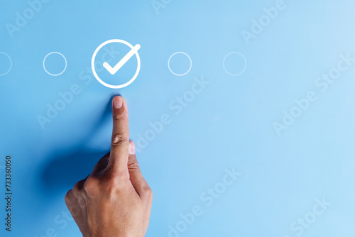 approval, approved, check, checkmark, choice, choose, confirm, correct, cross, decision. pointing at correct marks in round via finger on blue background color, the concept of choice without people. photo