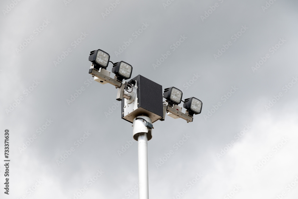 High-Intensity Security Lights Against Overcast Sky High-Intensity Security Lights Against Overcast Sky
