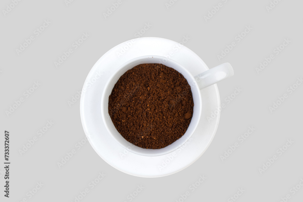A cup of ground coffee isolated on a gray background. top view.